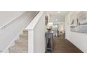 Elegant staircase with carpeted steps and neutral-colored walls at 2180 Monk Dr, Haw River, NC 27258