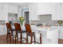 Beautiful white kitchen featuring a large island with barstool seating at 2721 Sanctuary Woods Ln, Raleigh, NC 27606