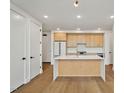 Bright kitchen features stainless steel appliances, light wood cabinets, white countertops, and a kitchen island at 29 Enterprise St # 309, Raleigh, NC 27607