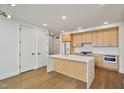 Bright kitchen features stainless steel appliances, light wood cabinets, white countertops, and a kitchen island at 29 Enterprise St # 309, Raleigh, NC 27607