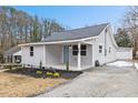 Newly renovated house with gray siding, landscaping, and a detached garage at 2917 State St, Durham, NC 27704