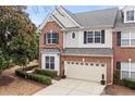 Exterior view of a red brick home with manicured landscaping and a two-car garage at 3020 Imperial Oaks Dr, Raleigh, NC 27614