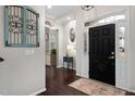 Foyer featuring a dark wood floor, neutral walls, and a stylish black front door at 3020 Imperial Oaks Dr, Raleigh, NC 27614