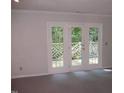 Living room with sliding glass doors leading to a deck and wooded area at 3122 Coachmans Way, Durham, NC 27705