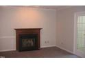 Living room featuring a fireplace and access to a patio at 3122 Coachmans Way, Durham, NC 27705