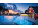 Community pool with water features and a red barn clubhouse at 314 Inspiration Way Way, Fuquay Varina, NC 27526