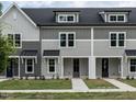 Three-unit townhome building, gray siding, white trim, and dark roofs at 315 E Fourth St, Wendell, NC 27591