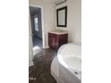 Bathroom with a soaking tub, dark vanity, and tile floor at 320 Eastfield Dr, Rocky Mount, NC 27801