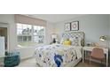 Bright bedroom with a queen bed, desk, and large window at 3600 Sorda Ct, Raleigh, NC 27610