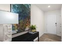 Bright entryway with a console table, lamp, and large artwork at 3605 Sorda Ct, Raleigh, NC 27610