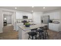 Modern kitchen with white cabinets, granite island, and stainless steel appliances at 3605 Sorda Ct, Raleigh, NC 27610