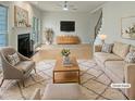 Bright living room featuring a fireplace, hardwood floors, and stylish neutral furniture at 408 Froyle Ct, Rolesville, NC 27571