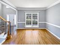 Bright living room with hardwood floors and large windows at 408 Froyle Ct, Rolesville, NC 27571