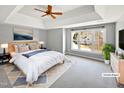Large main bedroom with tray ceiling, large windows, and carpeted floors at 408 Froyle Ct, Rolesville, NC 27571