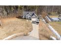 House with a gray roof and attached garage, situated on a wooded lot at 46 Trusting Ln, Middlesex, NC 27557
