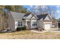 Two-story house with gray siding, a white door, and an attached garage at 46 Trusting Ln, Middlesex, NC 27557