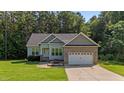 Charming single Gathering home featuring a brick and vinyl exterior, attached two car garage, and well maintained lawn at 46 Trusting Ln, Middlesex, NC 27557