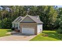 Charming single Gathering home featuring a brick and vinyl exterior, attached two car garage, and well maintained lawn at 46 Trusting Ln, Middlesex, NC 27557