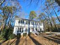 Two-story white house with black shutters, brick walkway, and American flag at 4909 Old Elizabeth Rd. Rd, Raleigh, NC 27616