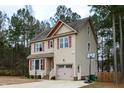 Two-story house with beige siding, red roof accents, and a basketball hoop at 496 Omaha Dr, Broadway, NC 27505