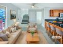 Virtually staged living room features a beige couch and a wooden coffee table at 502 Randolph Dr, Clayton, NC 27520