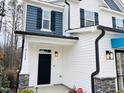Front entrance with black door and stone accents at 5112 N River Sand Trl, Raleigh, NC 27604