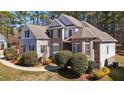 Elegant two-story home with a combination of brick and siding, showcasing mature landscaping and architectural details at 5637 Turner Glen Dr, Raleigh, NC 27603