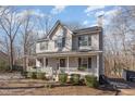 Two-story house with gray siding, white porch, and landscaping at 6224 Bridgemont Ln, Willow Springs, NC 27592