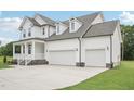 Lovely two-story home showcasing a three-car garage and inviting front porch at 92 Frost Meadow Way, Lillington, NC 27546