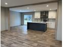 Modern kitchen with island, stainless steel appliances, and vinyl flooring at 1039 Branch Chapel Church Rd, Selma, NC 27576