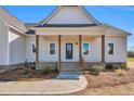 Inviting front porch with brick steps and wooden pillars at 1178 Sheriff Johnson Rd, Lillington, NC 27546