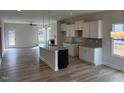 Modern kitchen featuring an island with a sink, stainless steel appliances, and tile backsplash at 135 Jones Creek Ln Ln, Lillington, NC 27546