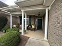 Front porch with rocking chairs and brick columns at 166 Easy Wind Ln, Garner, NC 27529
