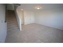 Unfinished basement area with carpeted floor and staircase at 1924 Robin Hill Ln, Raleigh, NC 27610