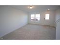 Bright and airy living room with carpeted floor and large windows at 1924 Robin Hill Ln, Raleigh, NC 27610