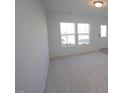 Bright living room with neutral carpeting and large windows at 1928 Robin Hill Ln, Raleigh, NC 27610