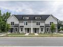 Three-unit townhome building with gray siding and white trim at 313 E Fourth St, Wendell, NC 27591