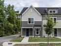 Two-story townhome with gray siding and a dark blue door at 313 E Fourth St, Wendell, NC 27591