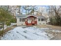 Brick ranch home with covered porch and snow covered yard at 402 Sparella St, Durham, NC 27703