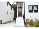 Modern front entrance with wood door and black metal railing at 508 Lakeland St # A, Durham, NC 27701