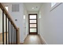 Light and airy entryway with hardwood floors and a modern staircase at 508 Lakeland St # B, Durham, NC 27701