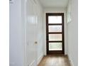 Bright entryway with hardwood floors, interior door, and coat closet at 508 Lakeland St # B, Durham, NC 27701