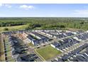 An aerial view of a residential community showcases houses, streets, green spaces, and a dense forest in the background at 51 Pansy Park # 234, Clayton, NC 27520