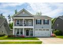 Beautiful two-story home featuring a welcoming porch, attached two-car garage, and lovely landscaping at 528 Ballast Pt, Clayton, NC 27520