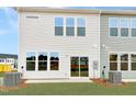 Rear view of townhome showcasing a private patio and backyard at 6 Nettle Ln # 245, Clayton, NC 27520