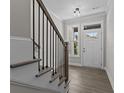 Bright entryway with staircase, hardwood floors, and a view to backyard at 607 Marshskip Way, Rolesville, NC 27571