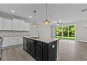 Open concept kitchen with island, stainless steel appliances, and access to backyard at 607 Marshskip Way, Rolesville, NC 27571