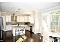Spacious kitchen with white cabinets, stainless steel appliances, and an island at 7713 Stonehenge Farm Ln, Raleigh, NC 27613