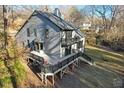 House back exterior view with deck and surrounding trees at 8309 Stryker Ct, Raleigh, NC 27615
