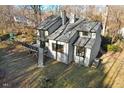 Back exterior view of house showcasing large deck and surrounding wooded area at 8309 Stryker Ct, Raleigh, NC 27615